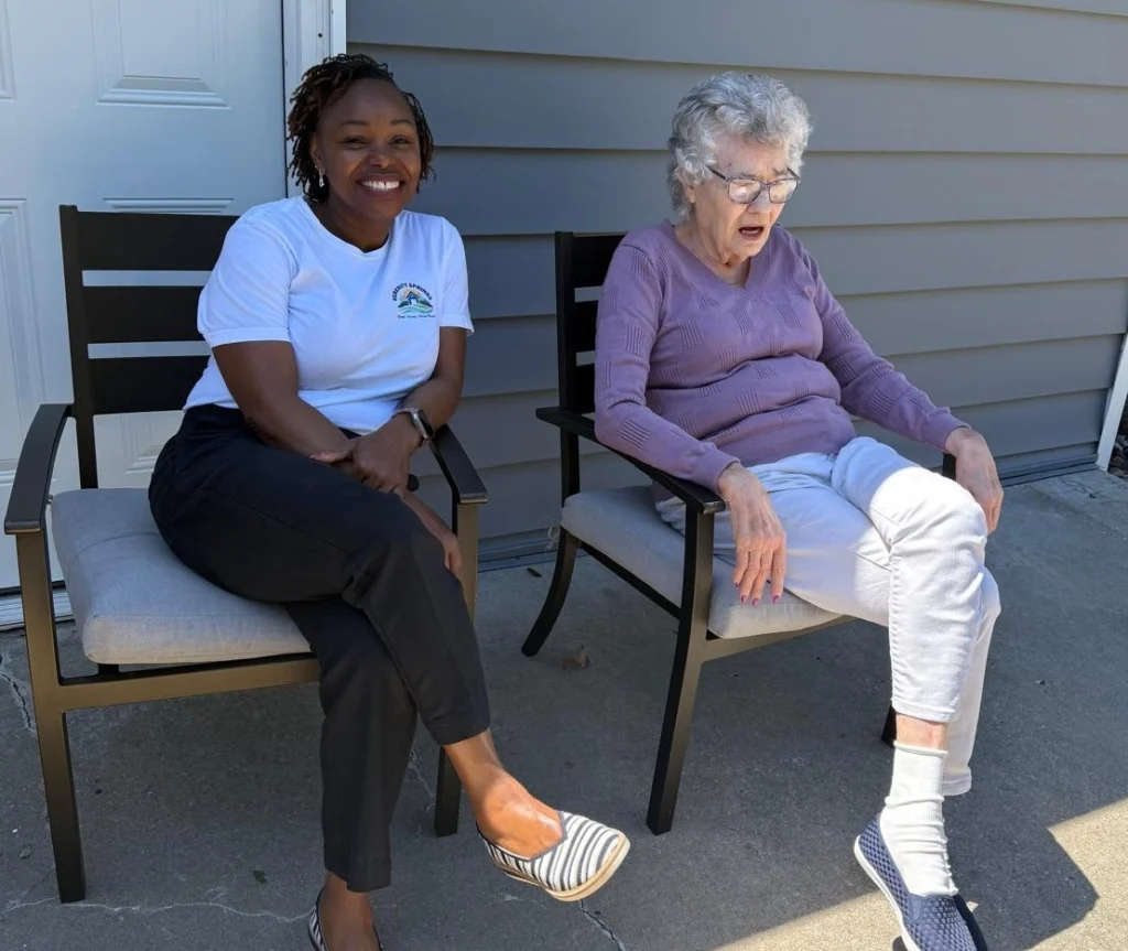Caregiver And Senior Resident Sitting Together On A Patio Talking In A Relaxed Outdoor Setting 1024x863