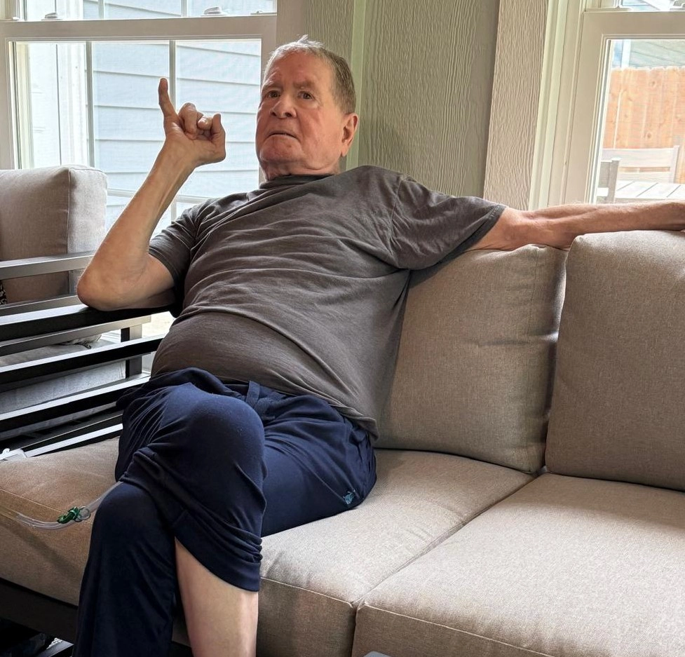 Services Elderly Resident Enjoying His Time While Seated In A Comfortable Chair