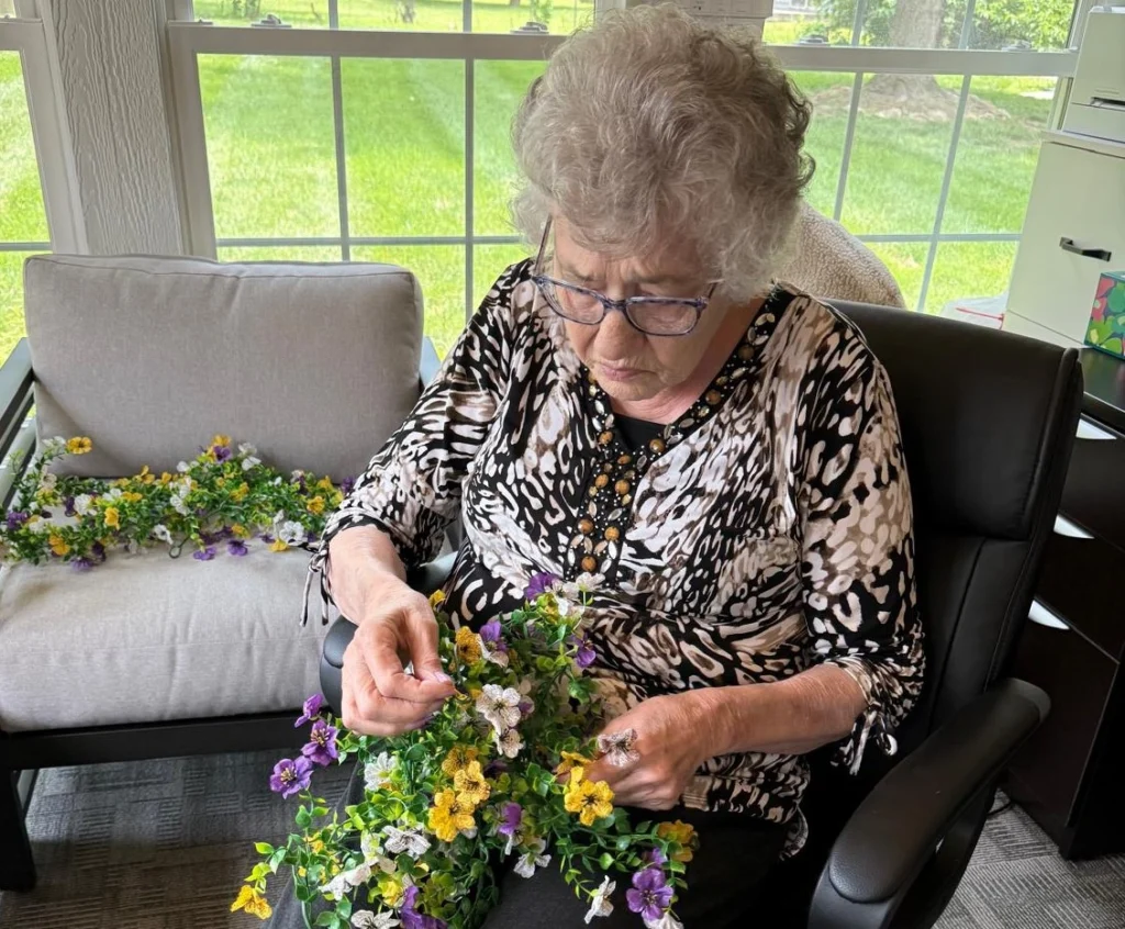 Senior Resident Arranging Handmade Flowers During A Craft Activity 1024x846