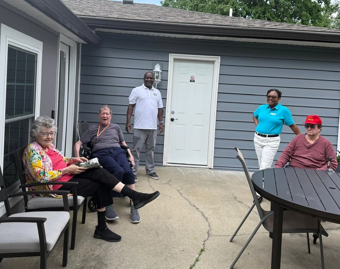 Senior Residents And Caregivers Enjoying A Peaceful Moment On The Patio