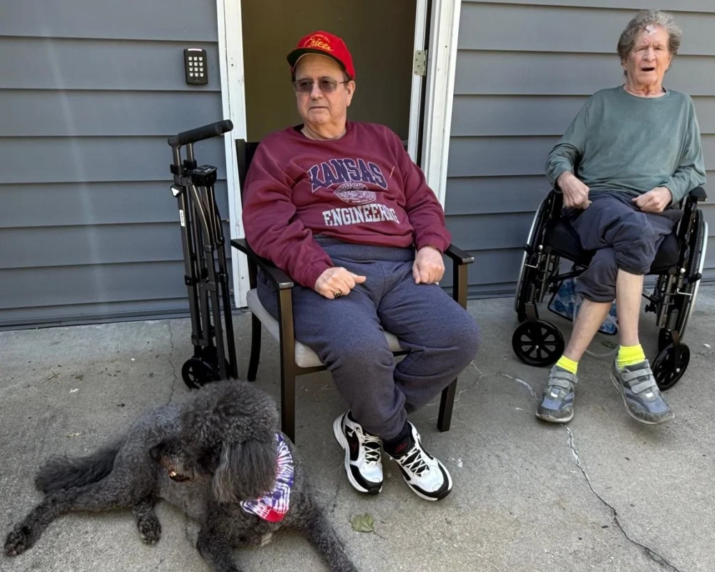 Senior Residents Relaxing With A Dog In A Comfortable Home Setting 1024x820